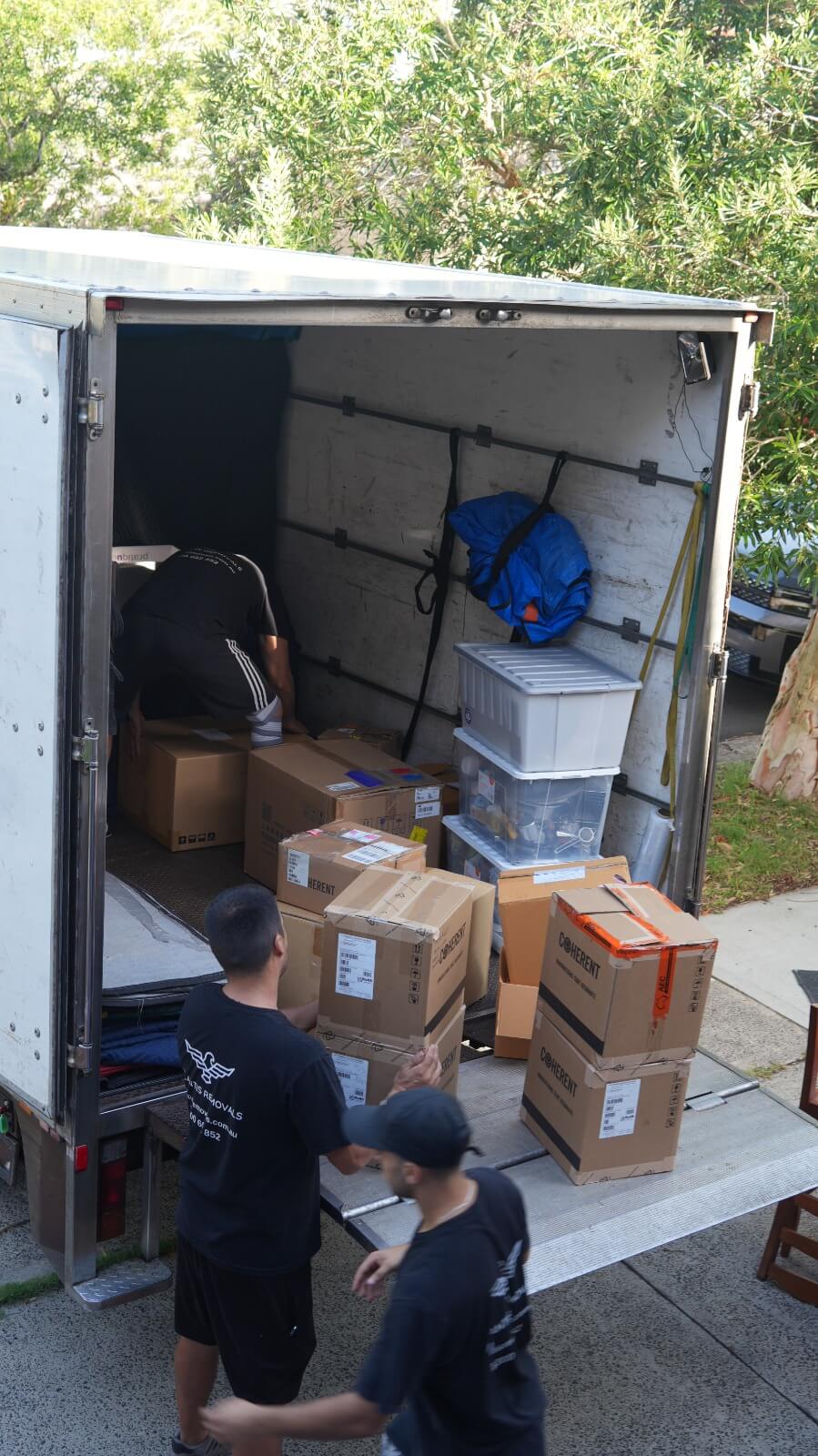 Atlantis Removals team carefully loading moving boxes into a truck for a residential home move in Newcastle.